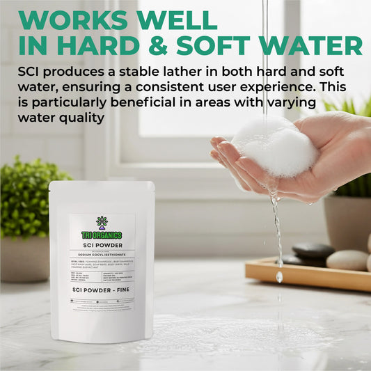 Hand holding foamy lather under running water next to SCI powder fine package on bathroom counter.